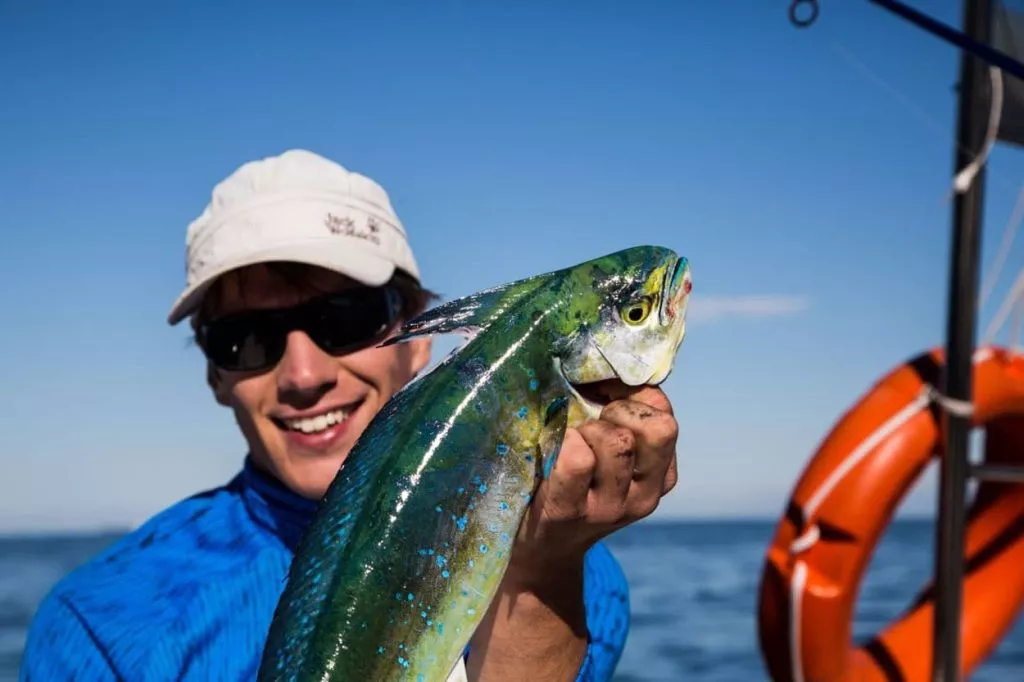 Fisherman holding a fish on a fishing trip