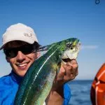 Fisherman holding a fish on a fishing trip